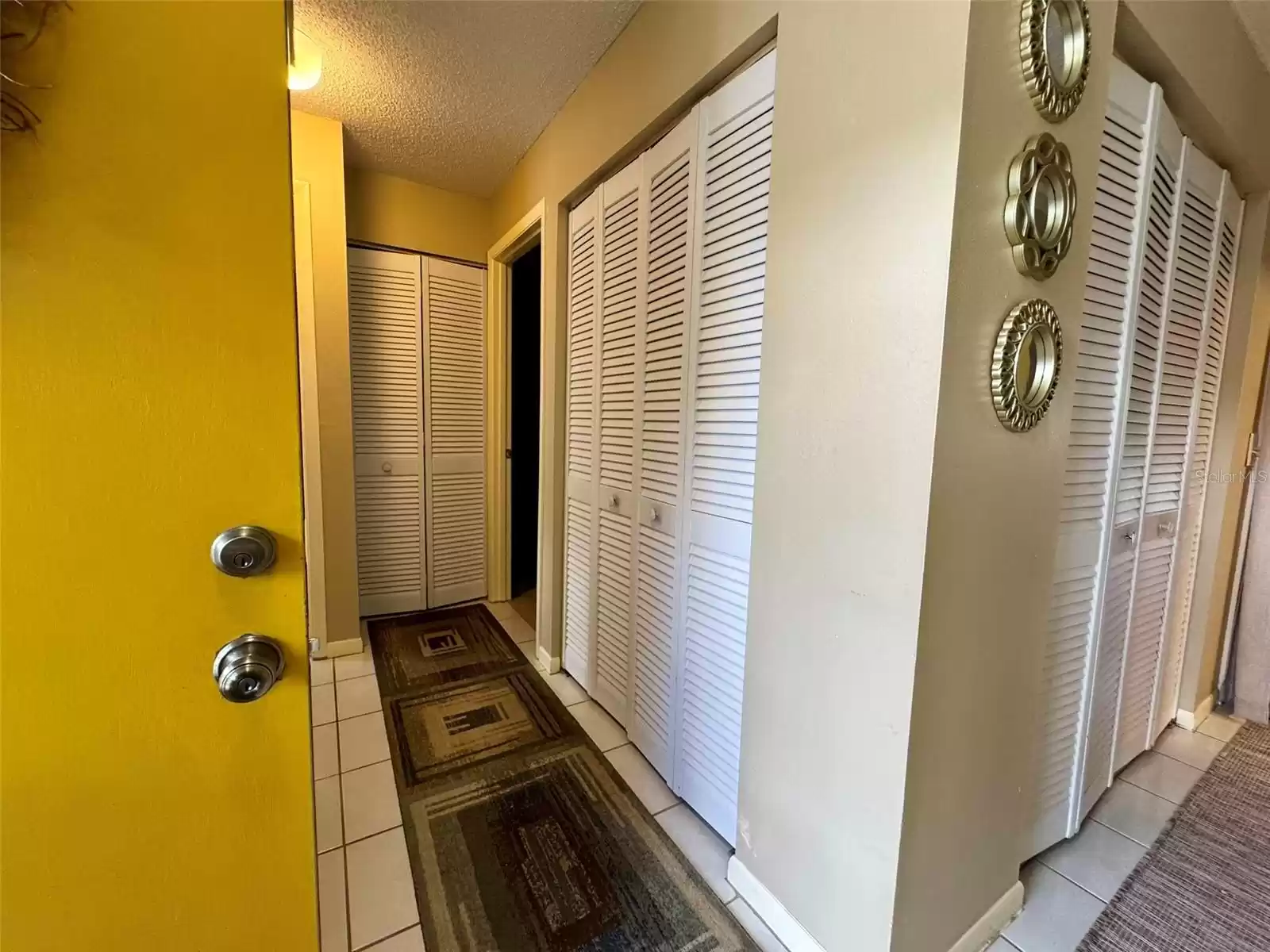 hallway with closet space and laundry area