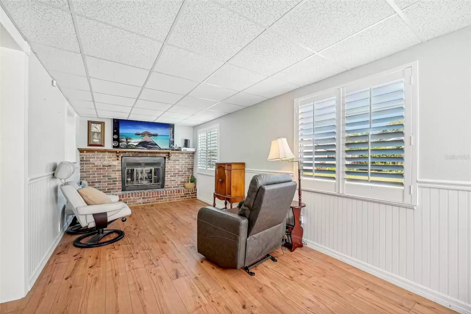 Enclosed Florida room with a wood burning fireplace. This would also make the perfect office or play room!