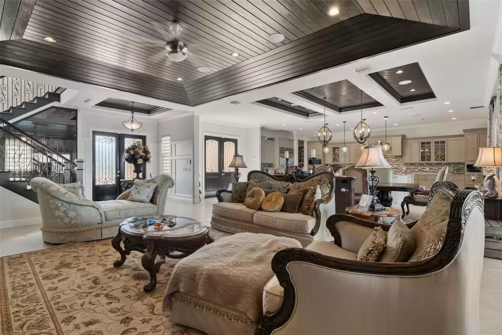 Great room open concept with elegant wood finished coffered ceiling