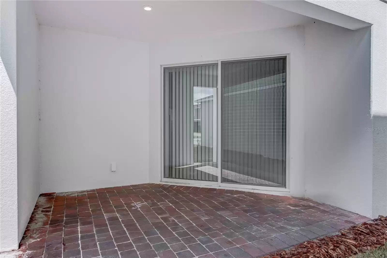 side covered patio for outside grilling and sitting