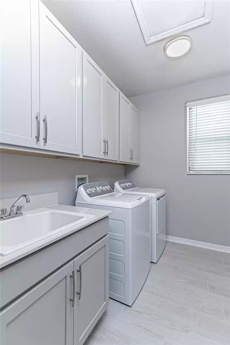 upstairs laundry room with washer & dryer, cabinets, sink and counter top - awesome!