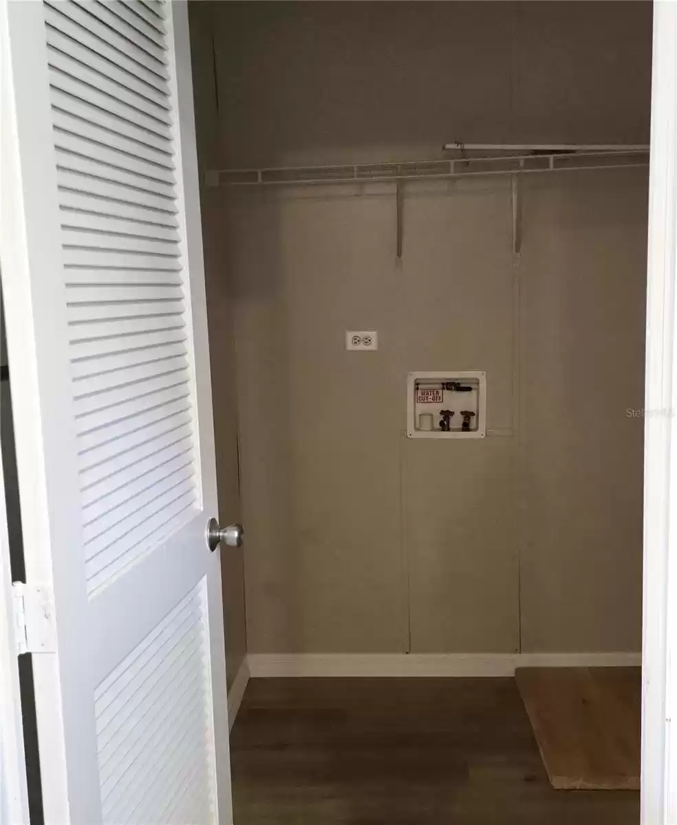 Off the opposite side of the kitchen is the large laundry room, which can also be utilized as a mud room as it houses the backdoor to the home.