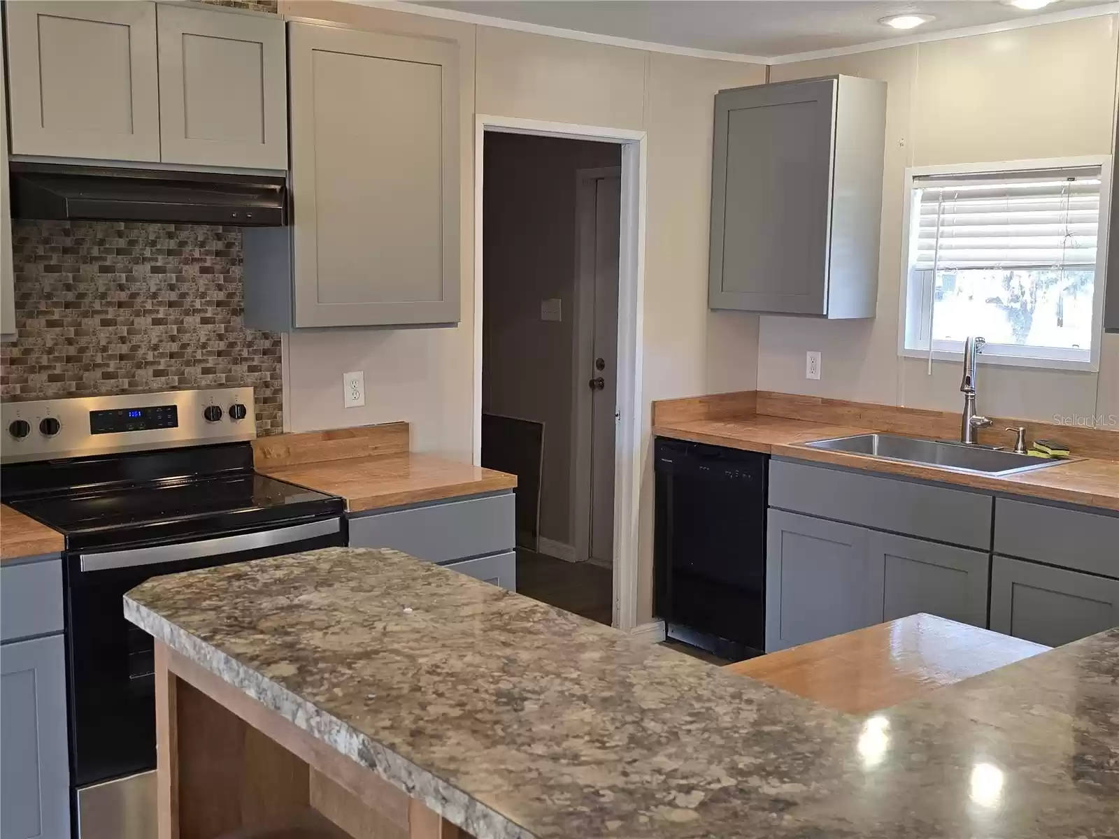 This gorgeous kitchen has brand new cabinets creating ample storage space.