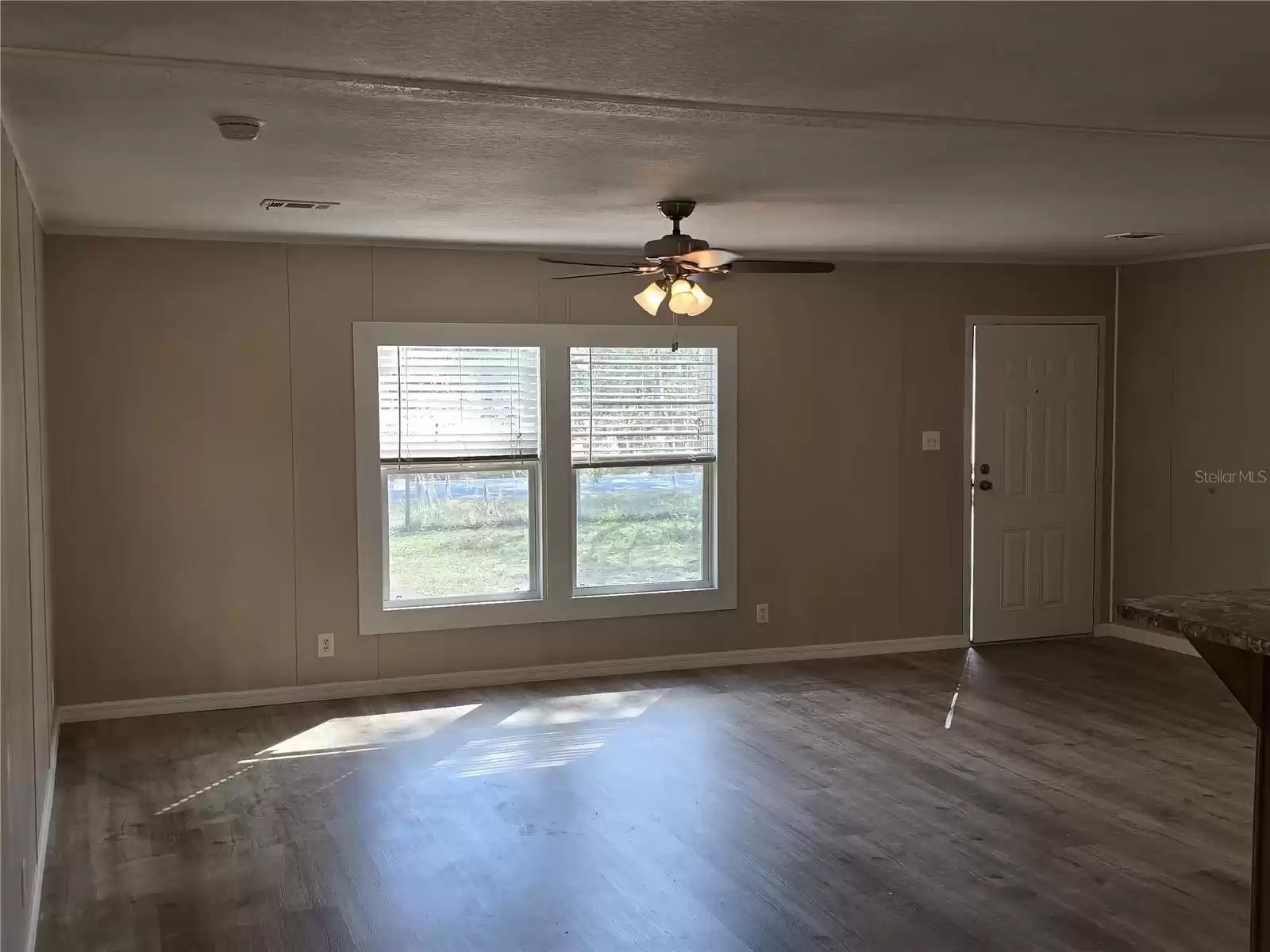 Upon entering the home, you will notice the large living room with new laminate flooring.