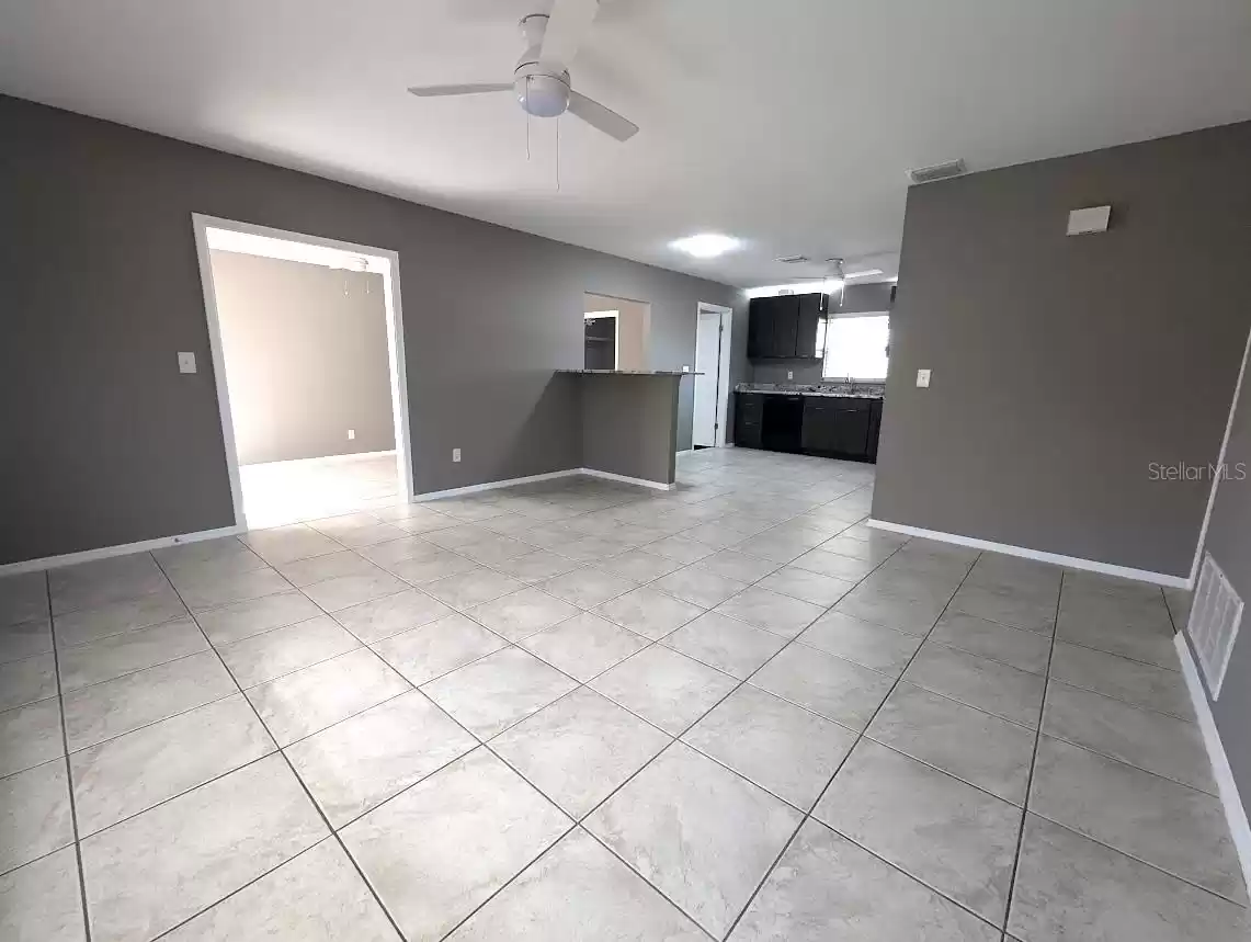 Living room with view to kitchen and family room