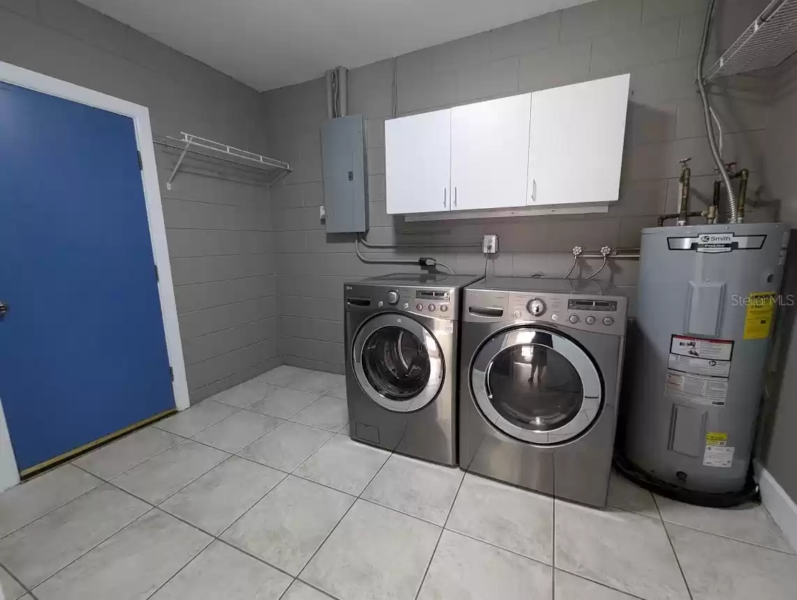 Spacious laundry room with new stainless steel front loading washer / dryer