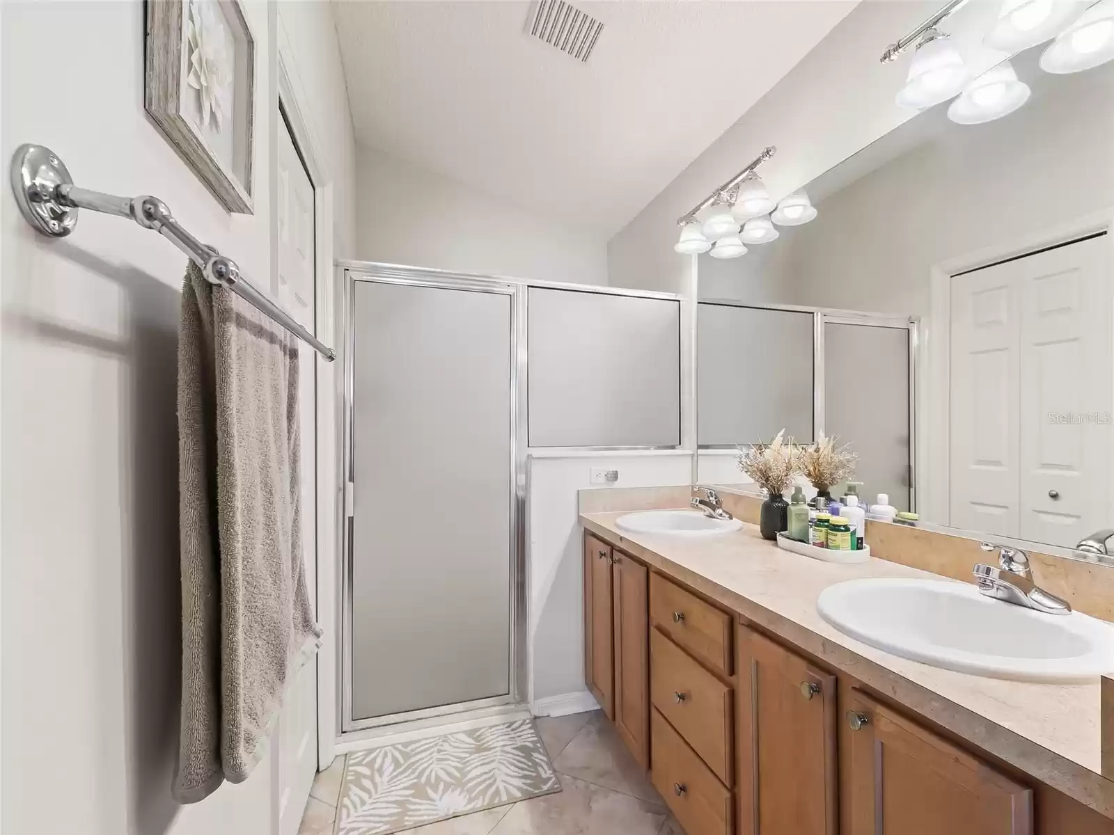 Primary bath with double vanities and walk in closet