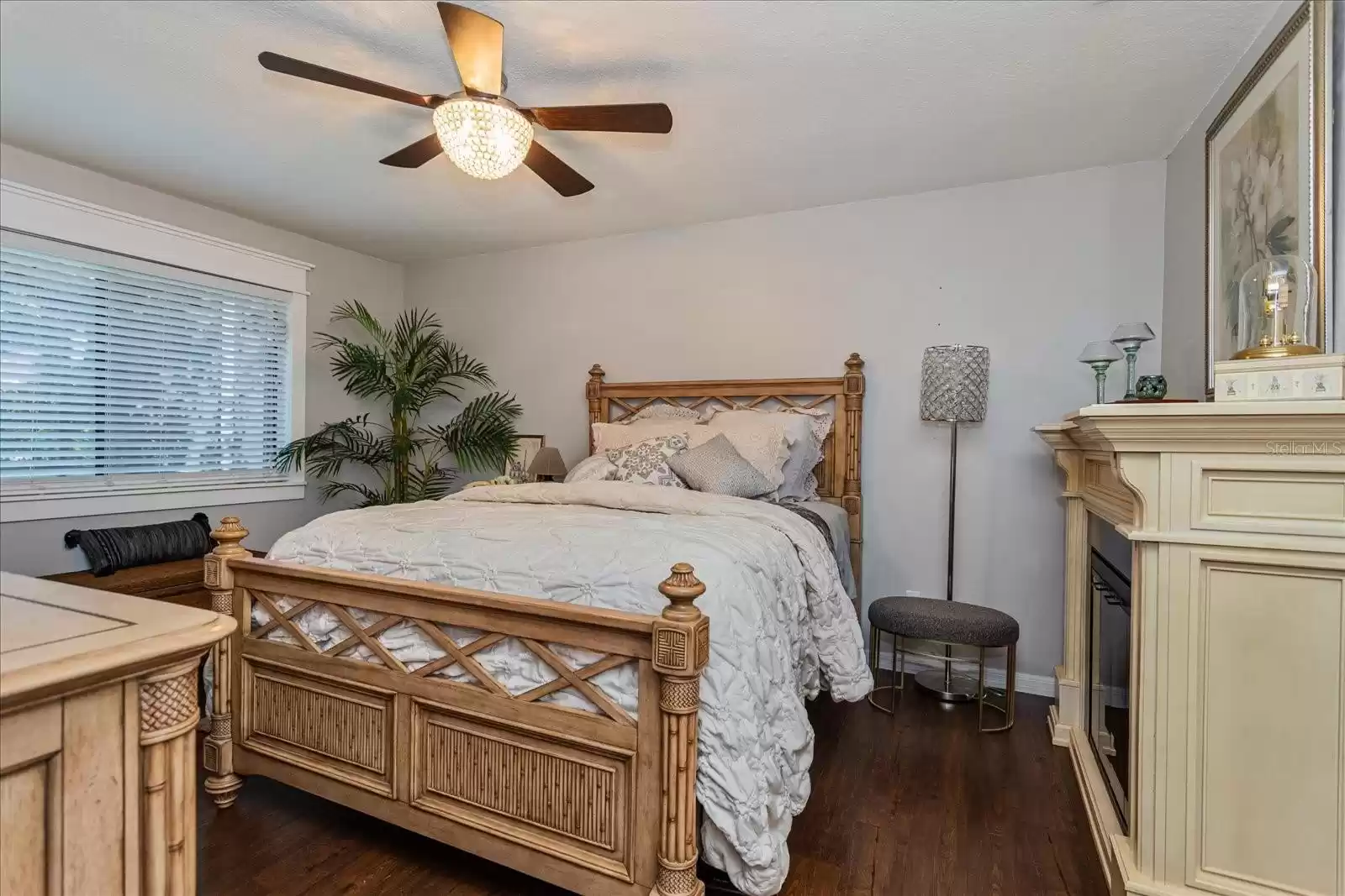 Primary bedroom faces the rear pool area and includes a fan with light fixture.