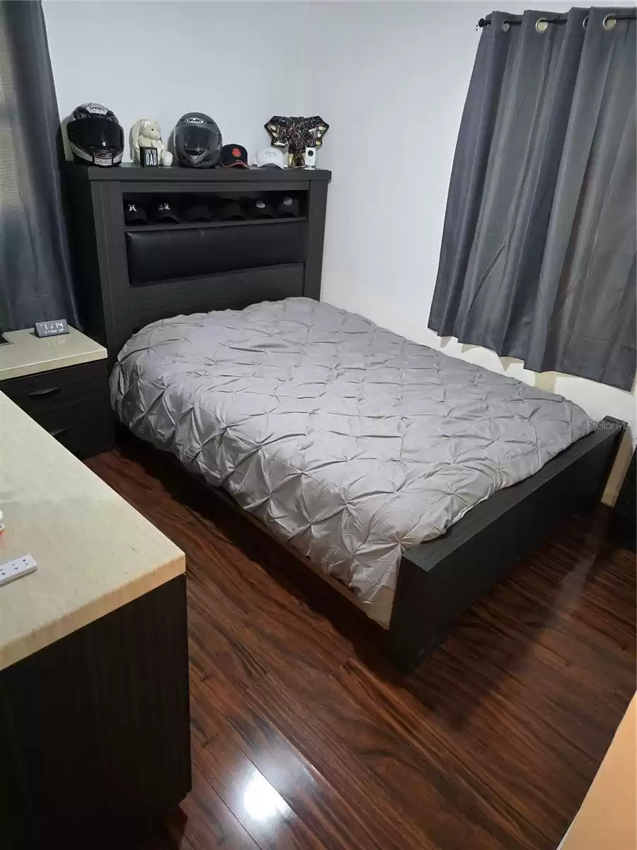 Main bedroom with new flooring and 2 windows.