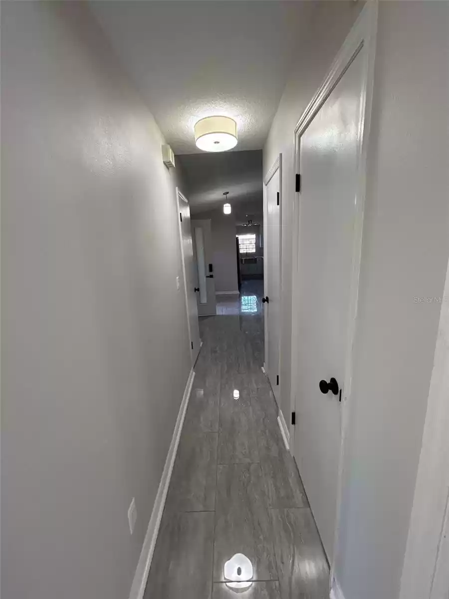 Hallway with linen and coat closet