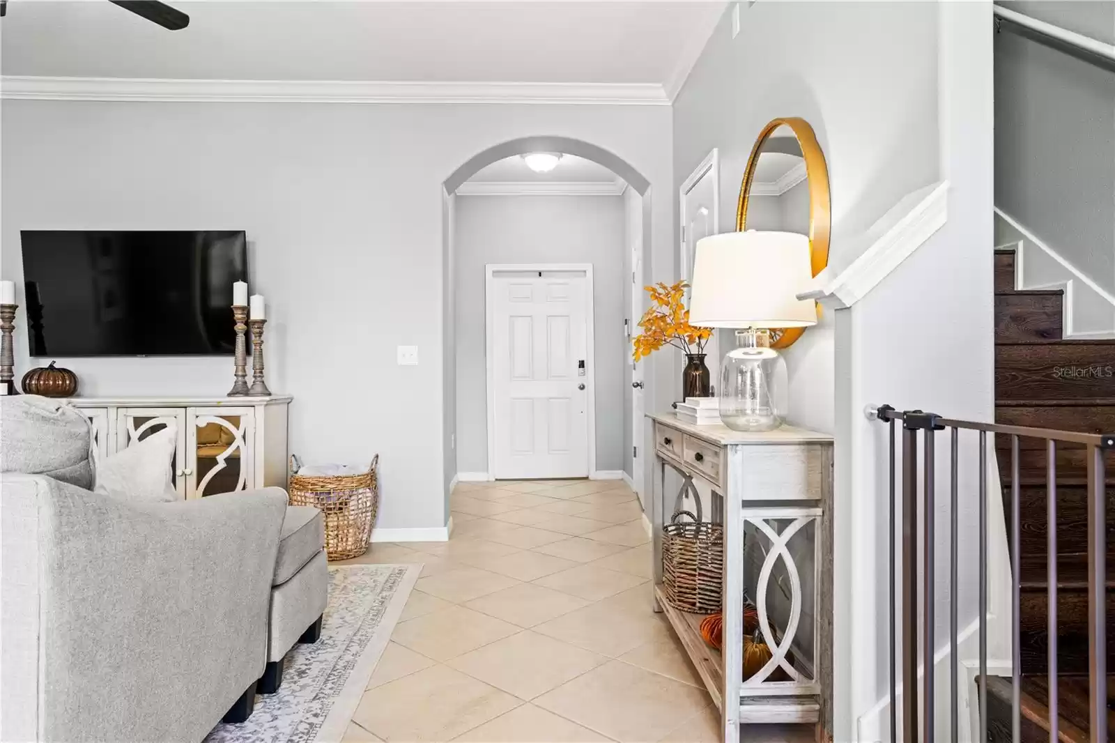 View of entry way and stairs from kitchen