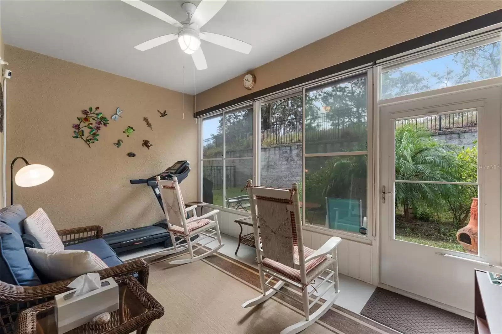 Enclosed Lanai with retractable awning that also covers the papered patio