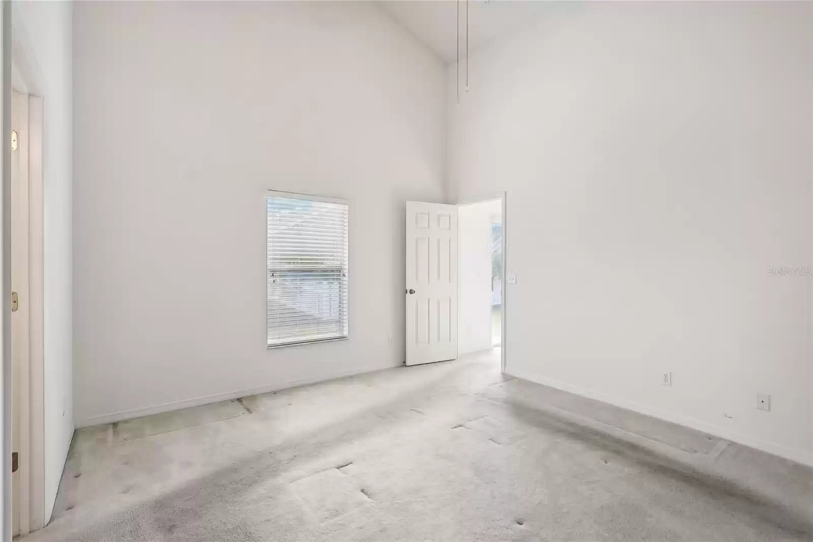 Primary bedroom with vaulted ceilings