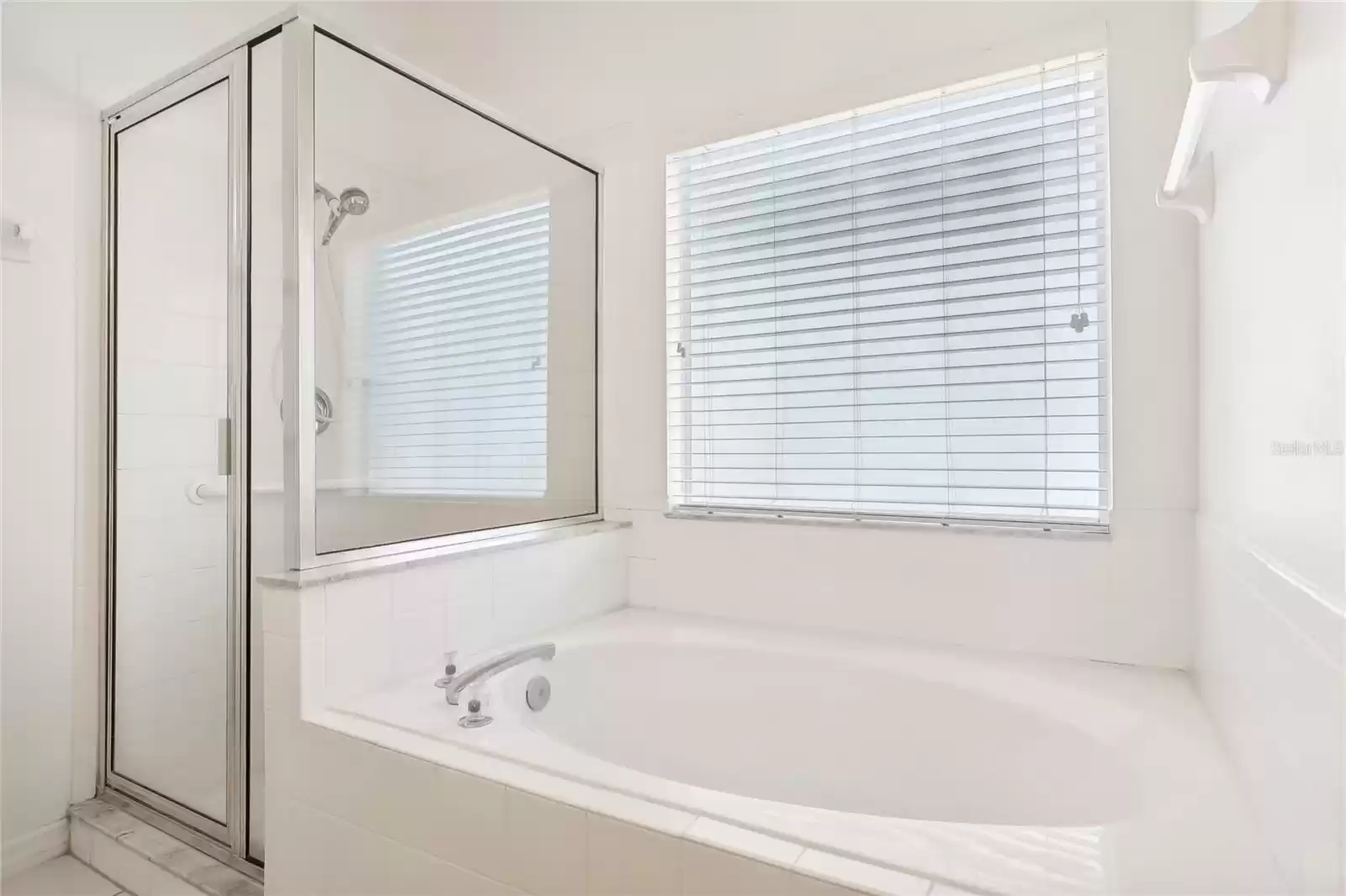 Soaking tub & separate shower in the primary bath.