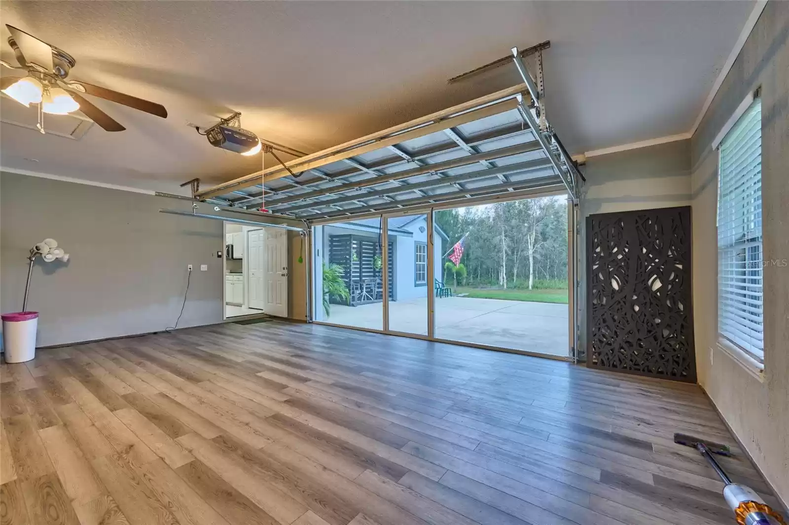 Garage has a finished floor, retractable screen door and can be multi-functional if desired.