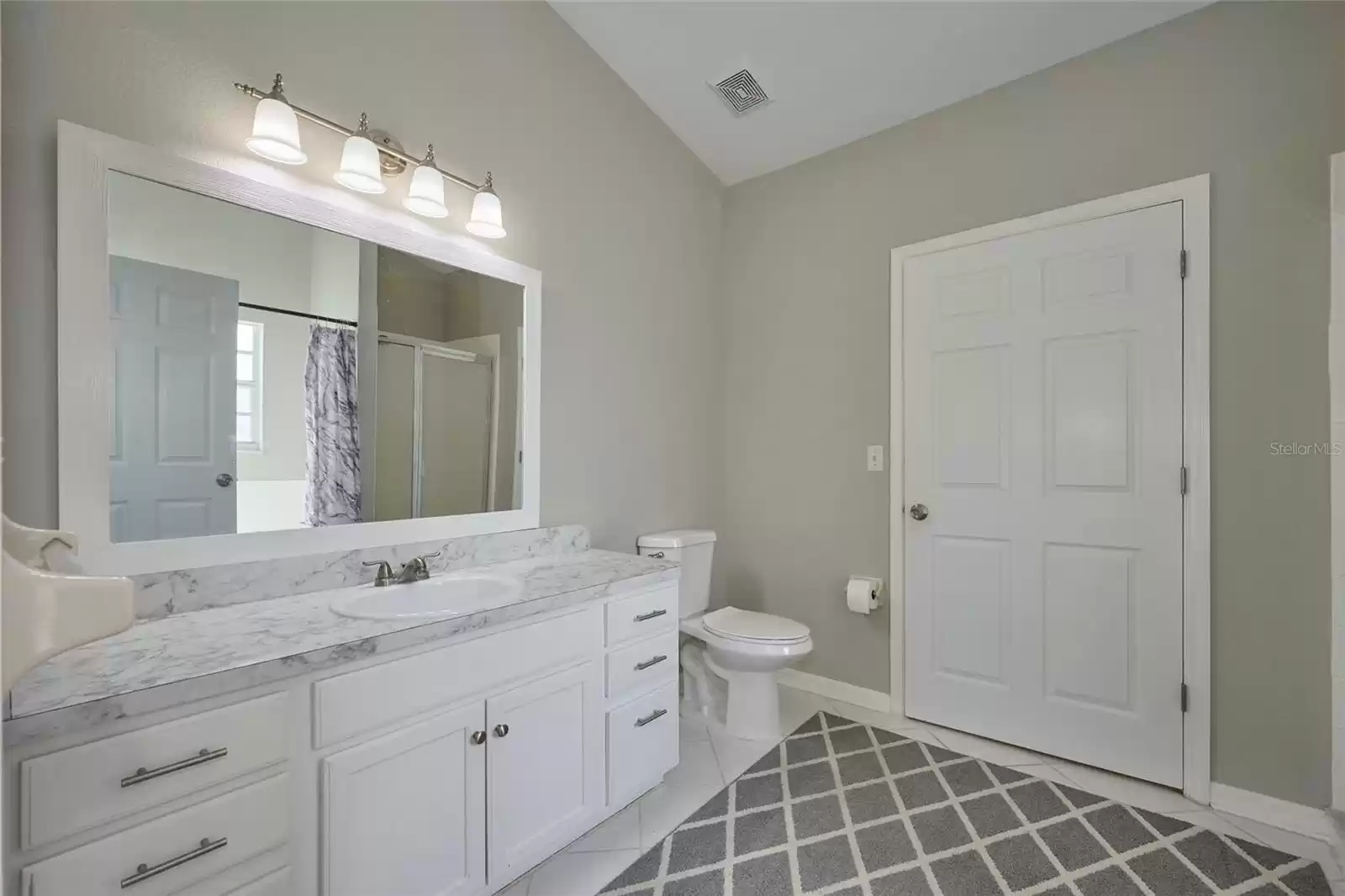 Vanity area in master bathroom.  Door opens to walk-in closet.