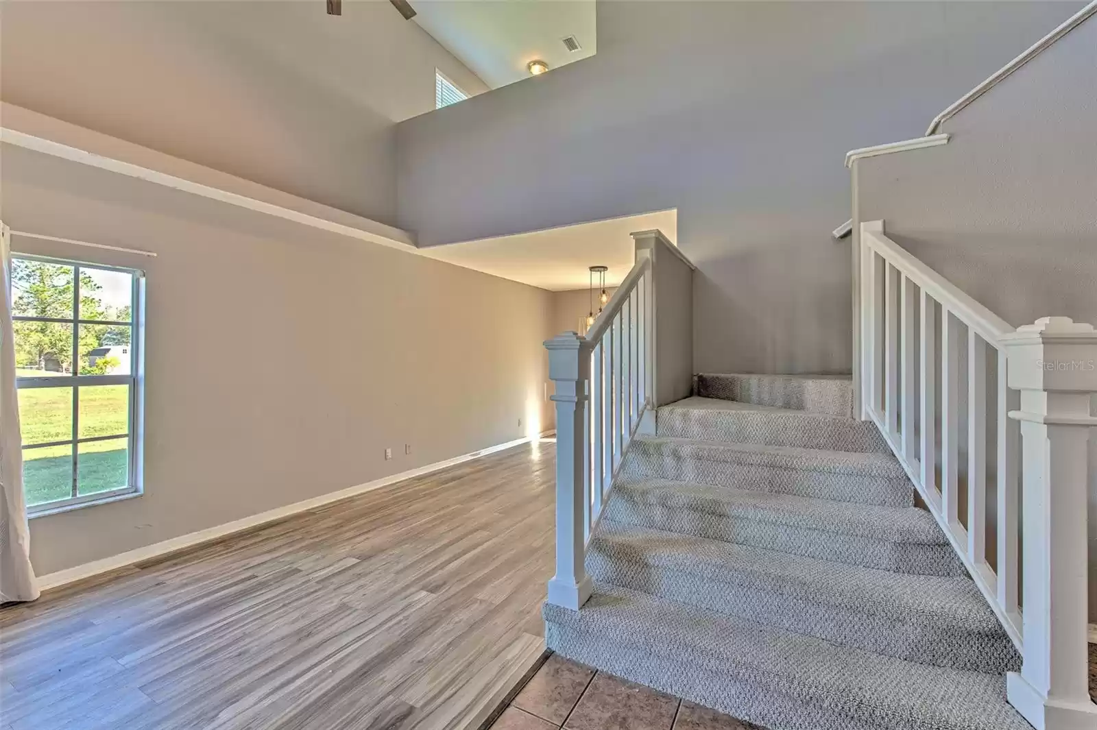 Open Floor Plan, View of Loft, Grand Staircase, 18ft Vaulted ceiling