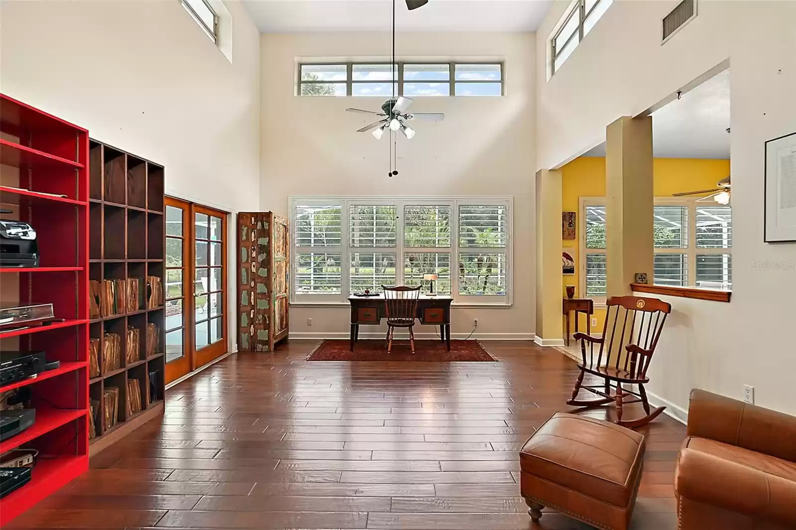 The family room overlooks the covered patio and is adjacent to the breakfast nook and kitchen. Here, bookcases line the walls of the current owner's family room.