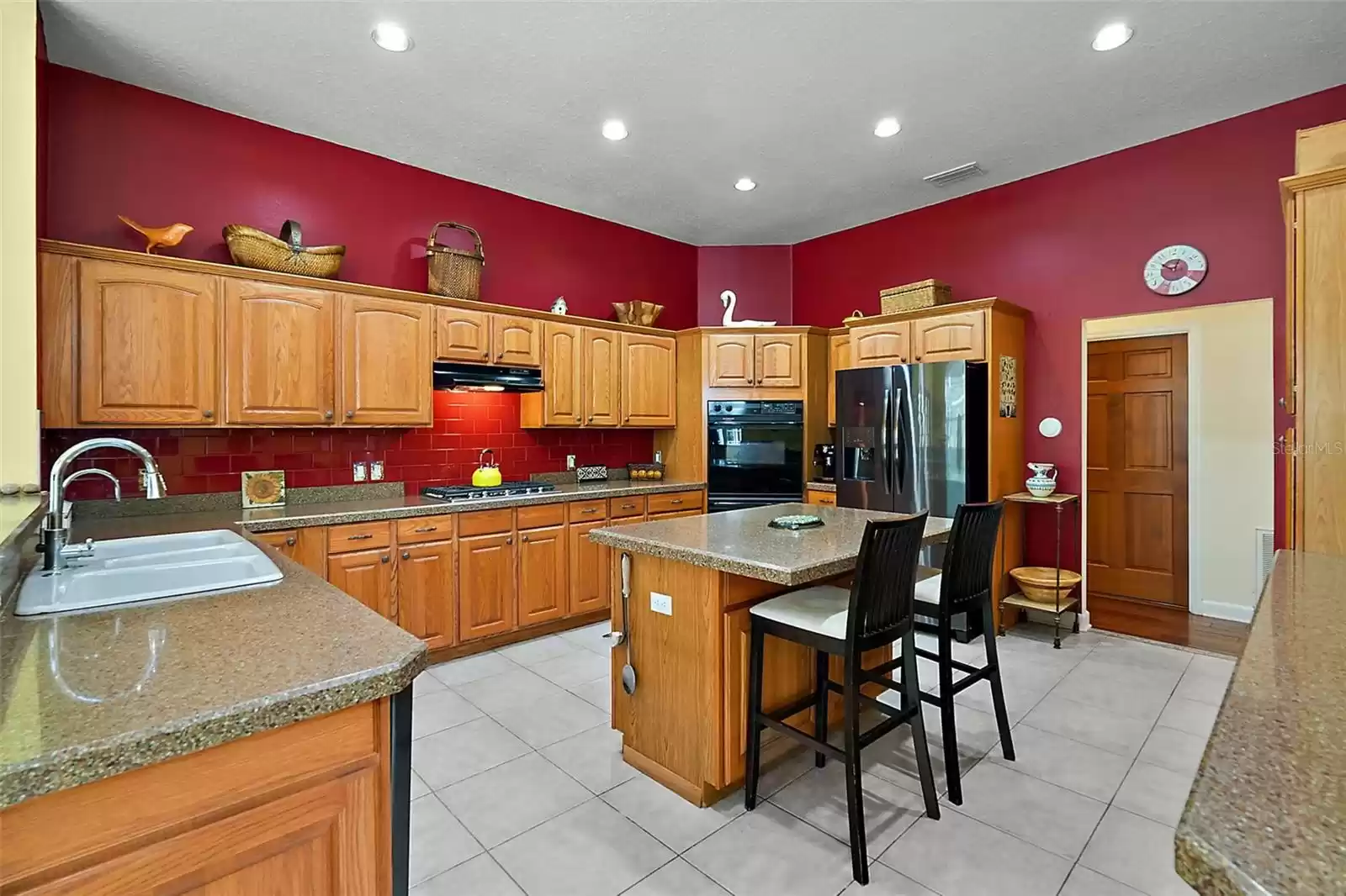 Family and guests will gather in the spacious 18 x 15 kitchen, where the chef can enjoy a five-burner cooktop and double oven.