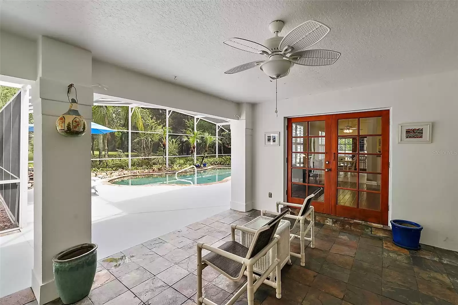 Whether from the family, living, or owner's suite, each has double doors leading you to this covered patio and screened pool.