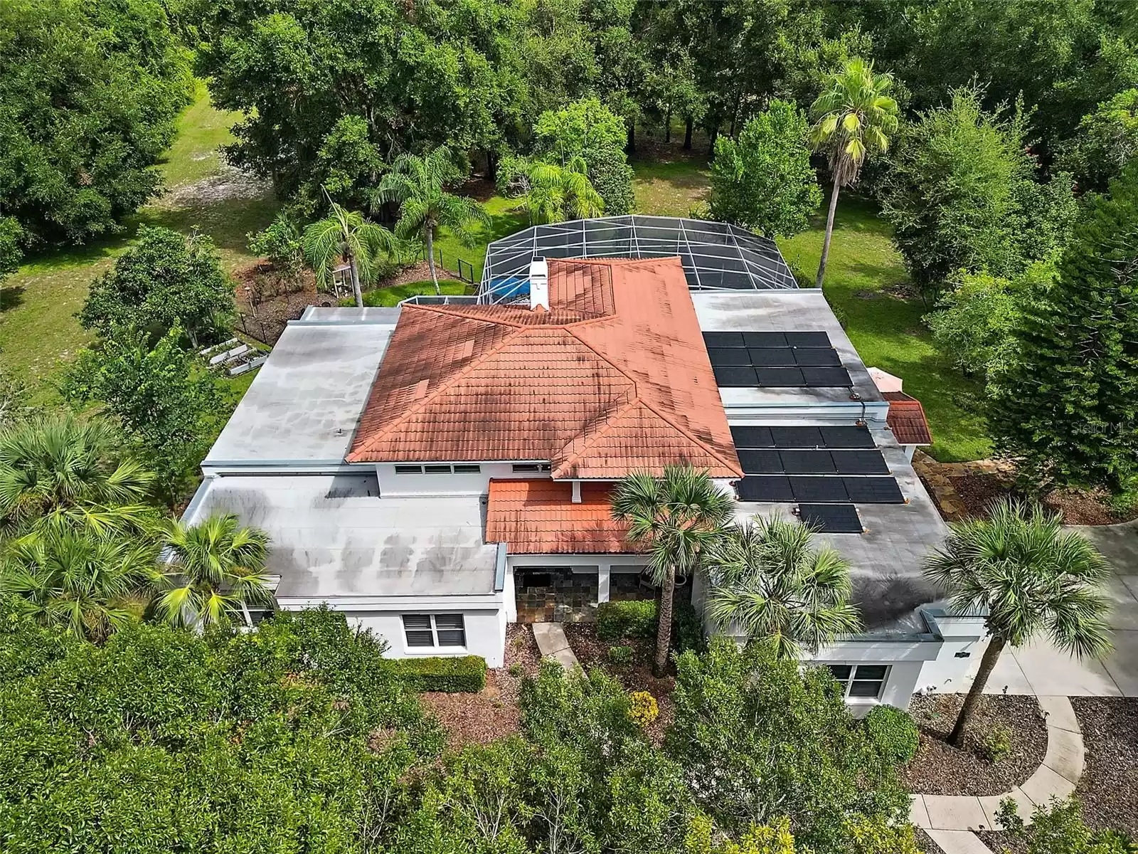 New flat roof installed 2019.  Steel-coated metal tiles have a 50 year life.  Solar panels power the house and are paid off.