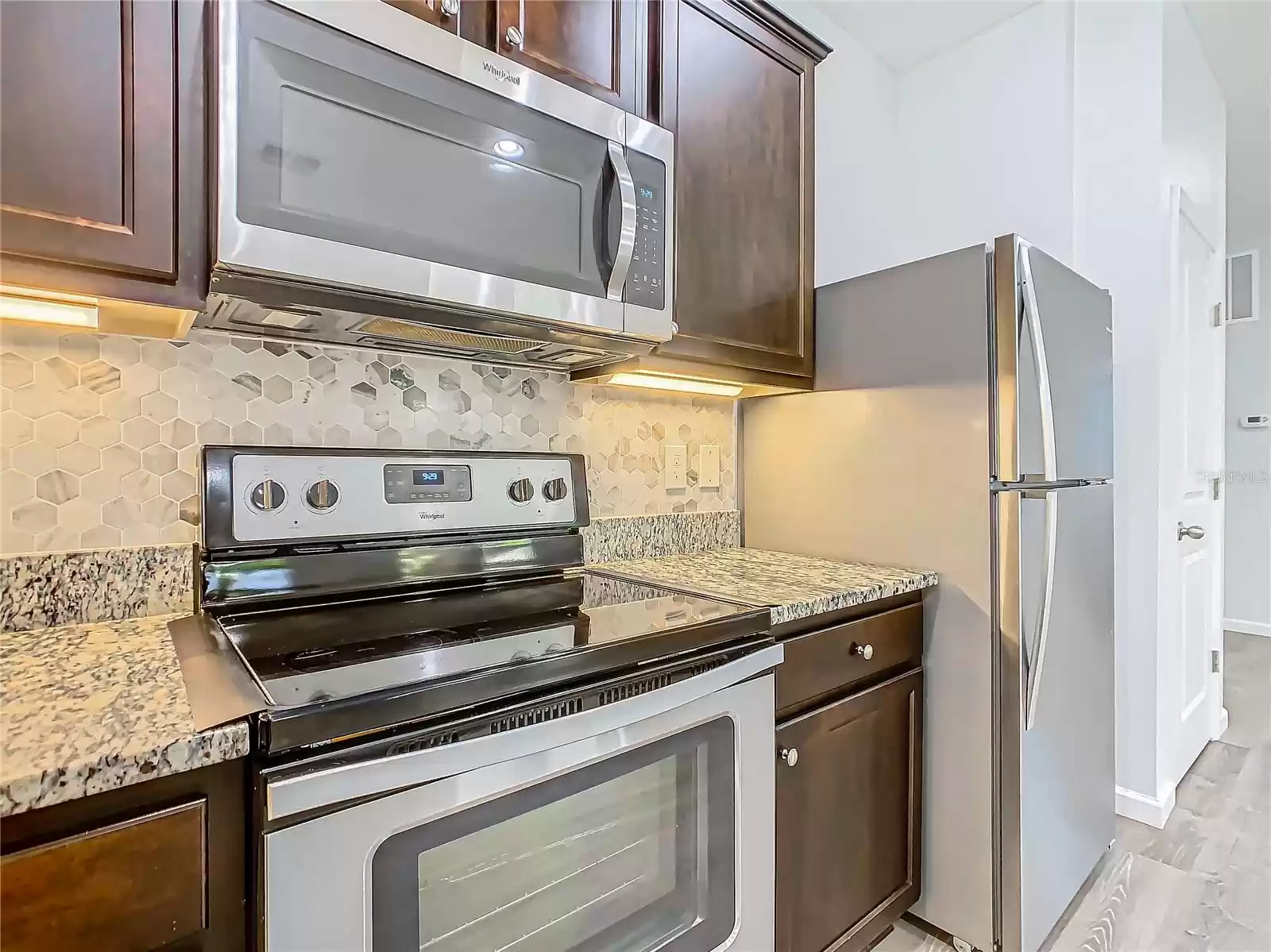 The kitchen has stainless steel appliances.