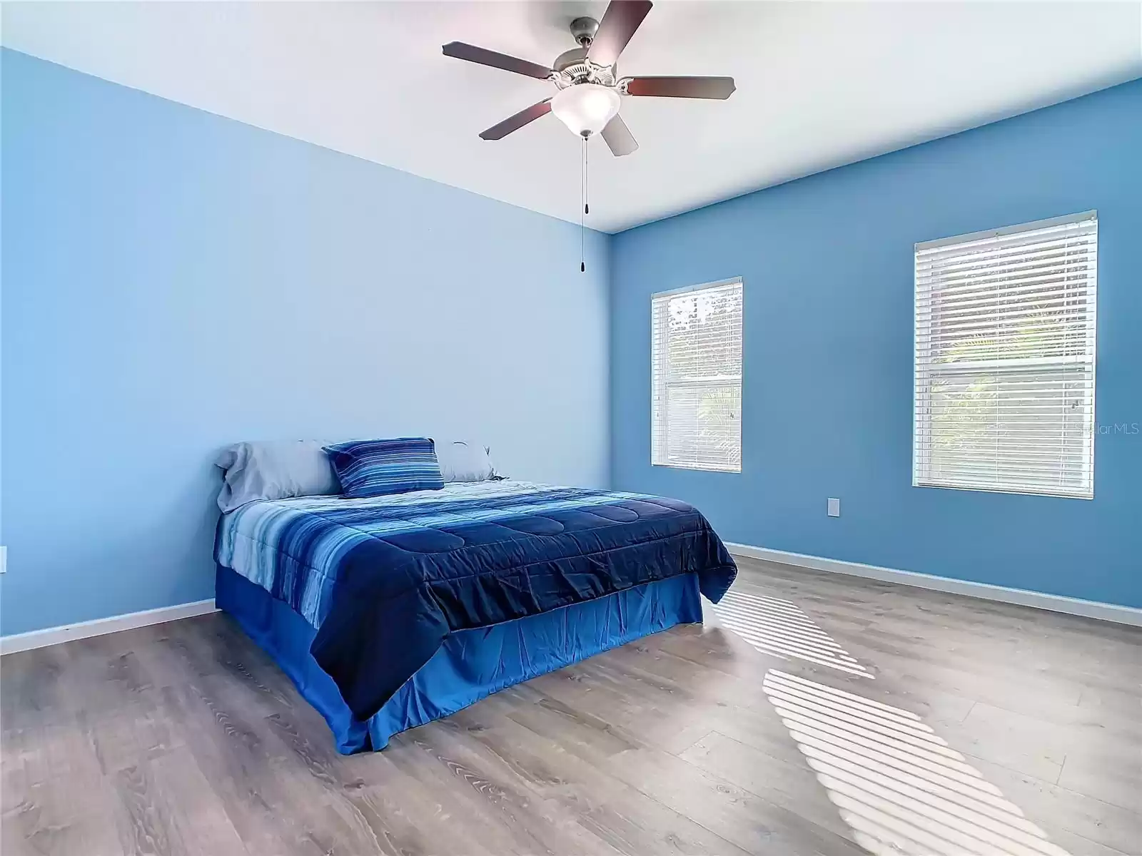 Primary bedroom with new vinyl flooring.