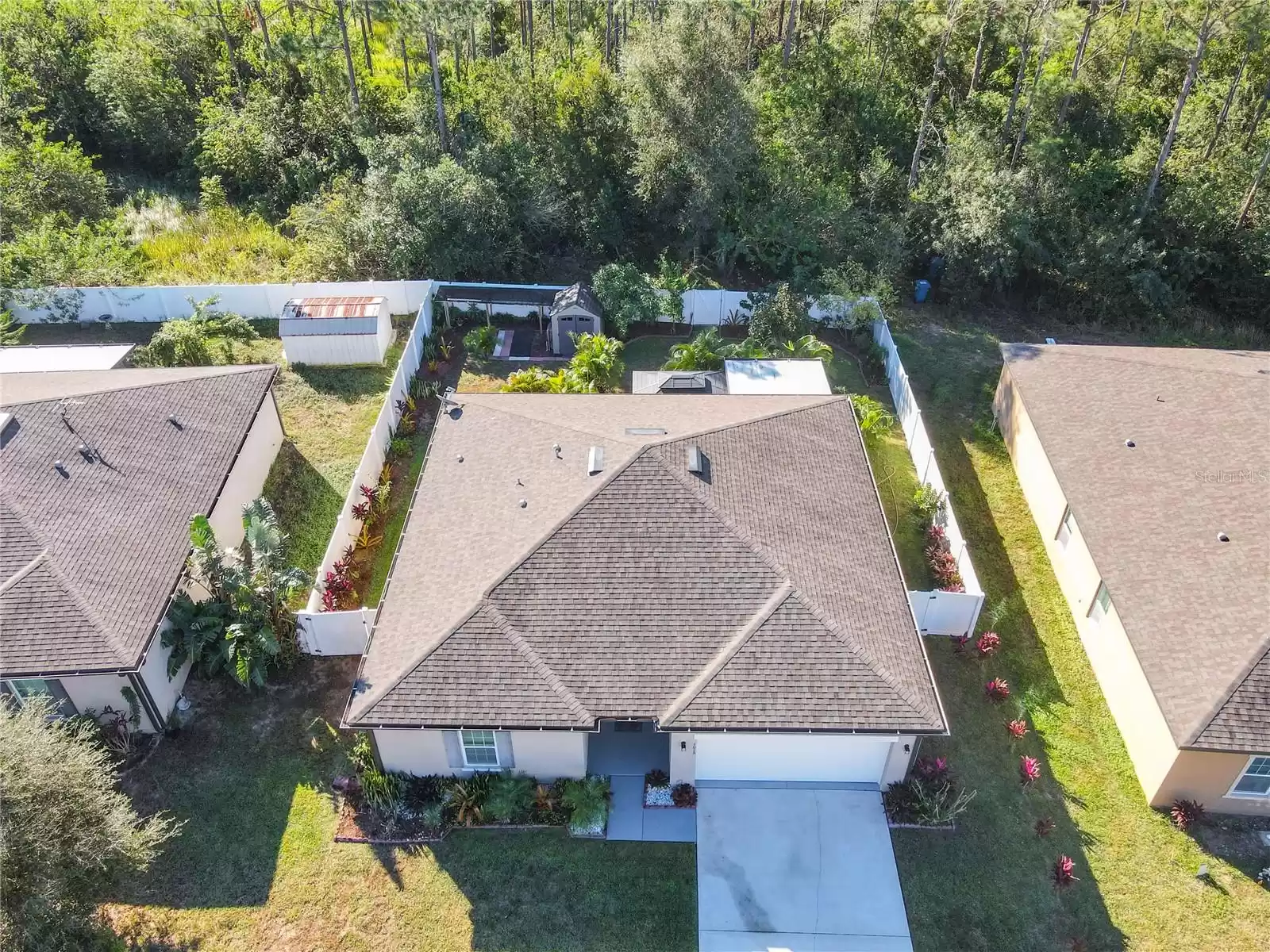 The backyard looks like a tropical backyard retreat with screened patio, gazebo, privacy with no backyard neighbors and lush landscaping.