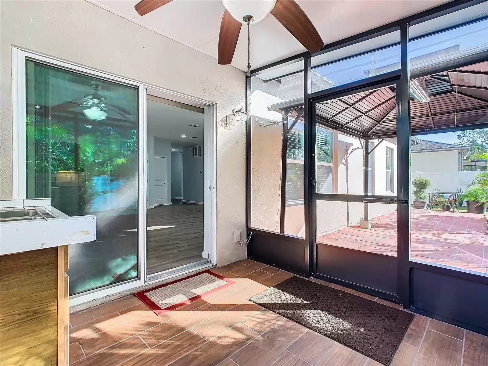 Sliding glass doors open to the home and the walk door leads to the gazebo and the backyard.