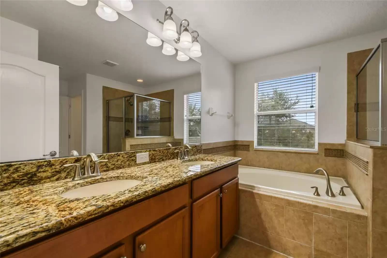 Beautiful granite countertos, double sinks, stylish faucets and lighting!