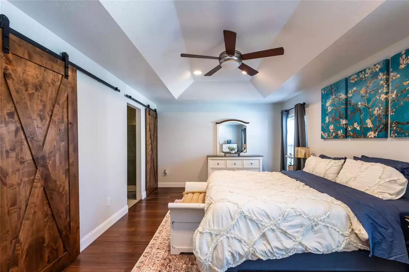 First barn door leads to a large walk-in closet.