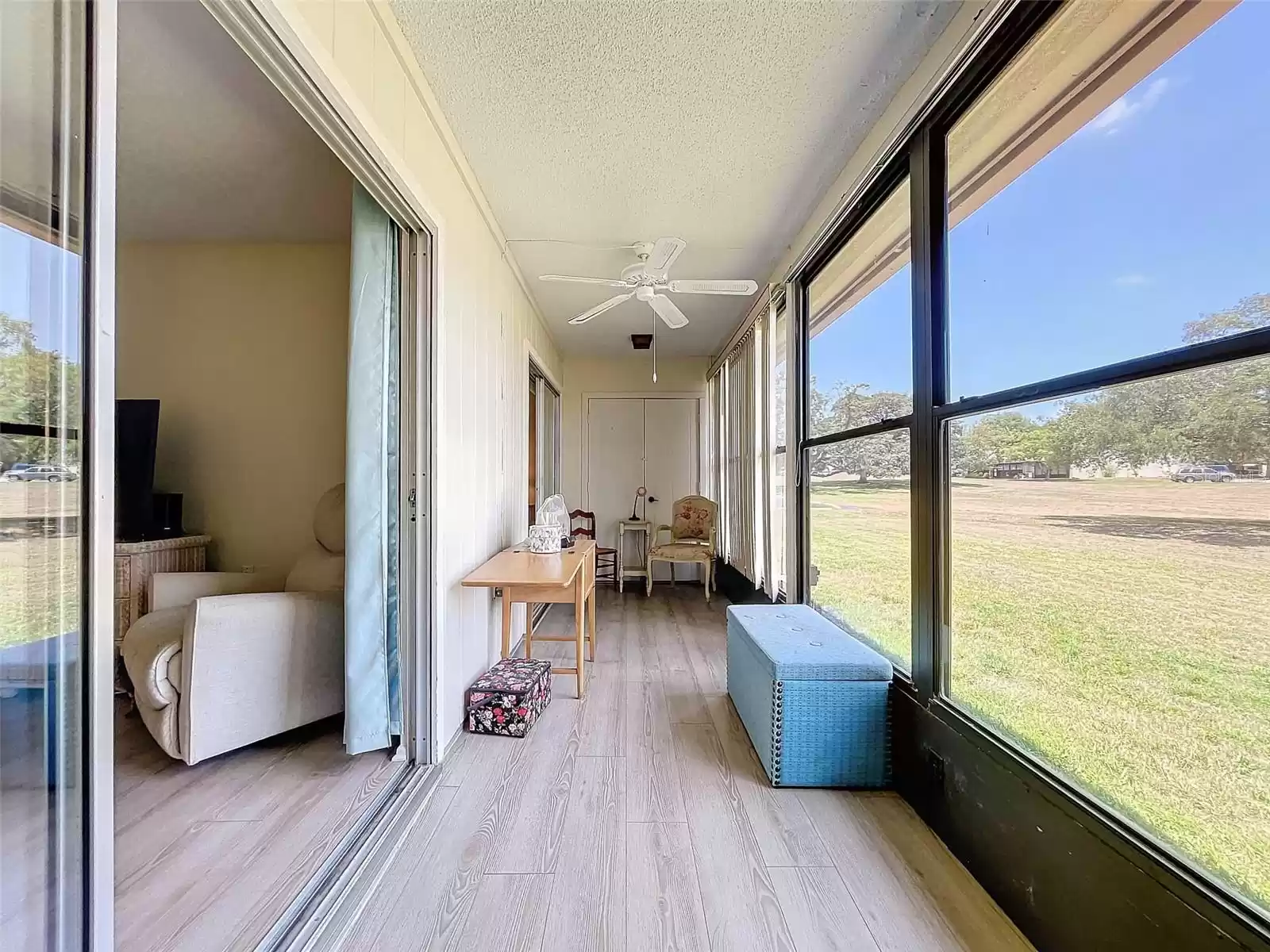 Glass Enclosed Patio has sliders from Living Area & Primary Bedroom