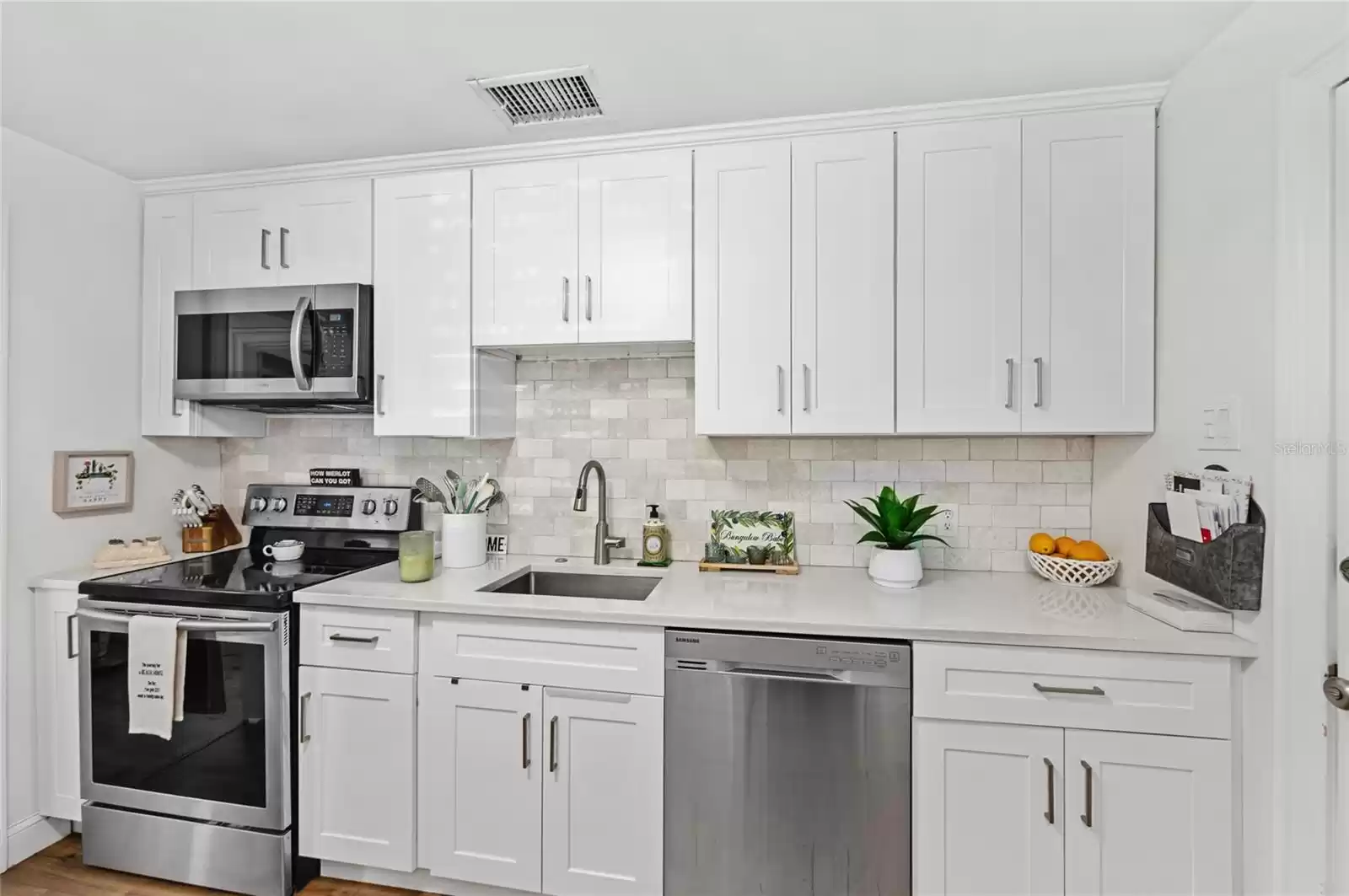 Renovated kitchen with quartz countertops.