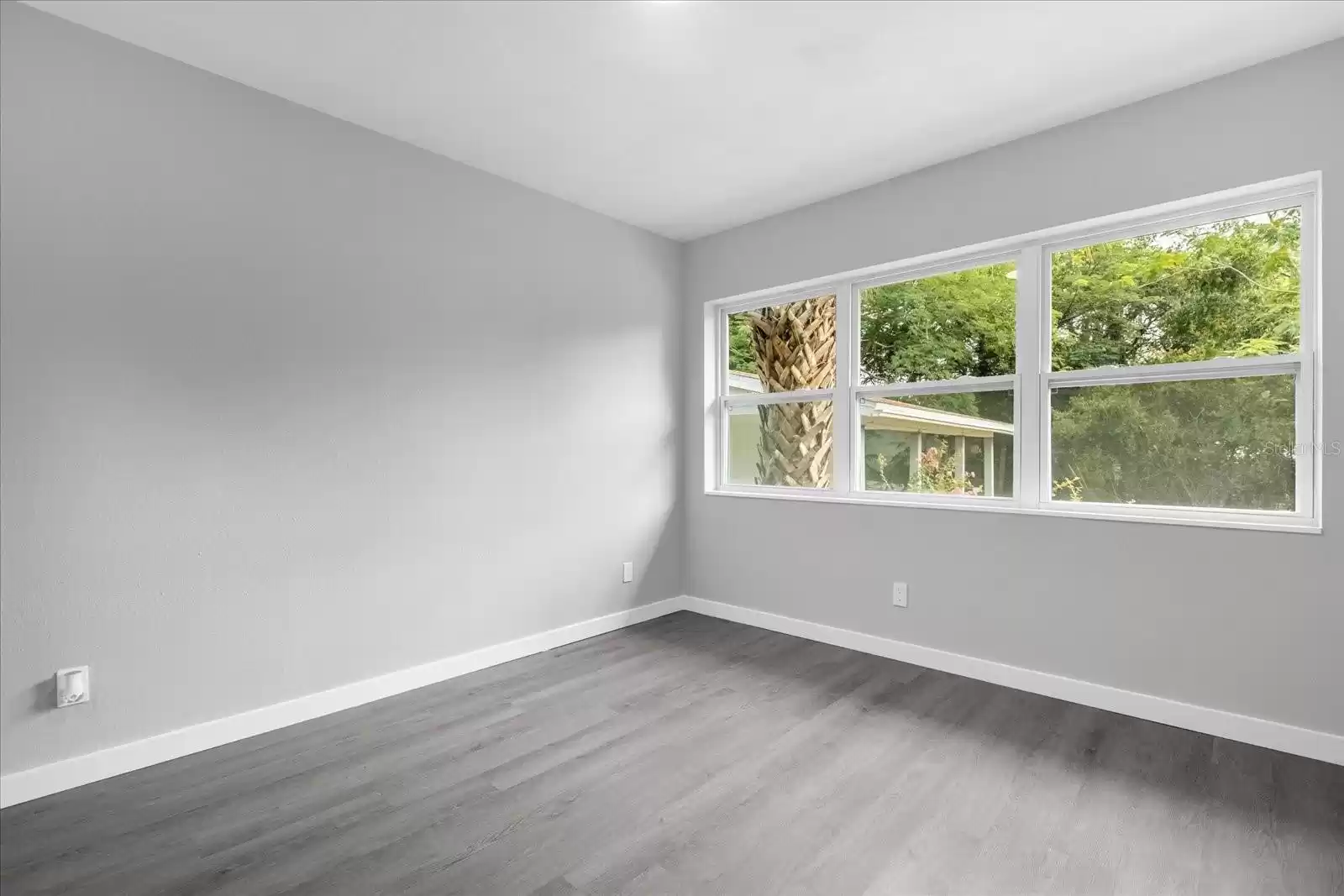 master bedtroom big windows overlooking the backyard.