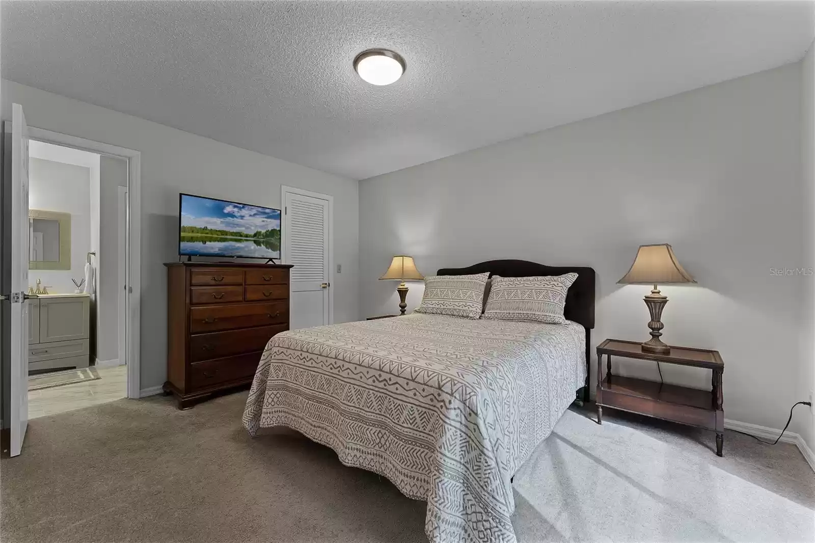 Bedroom with walk in closet and Jack and Jill Bathroom plus Pool view. Carpeted