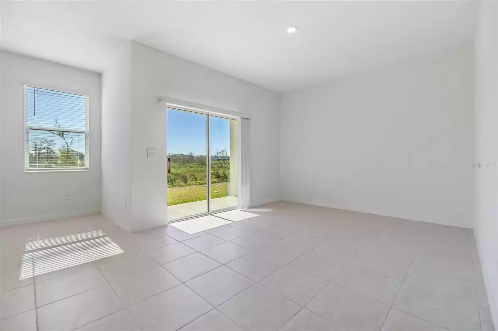 Loads of natural light with sliding door to open patio and natural views