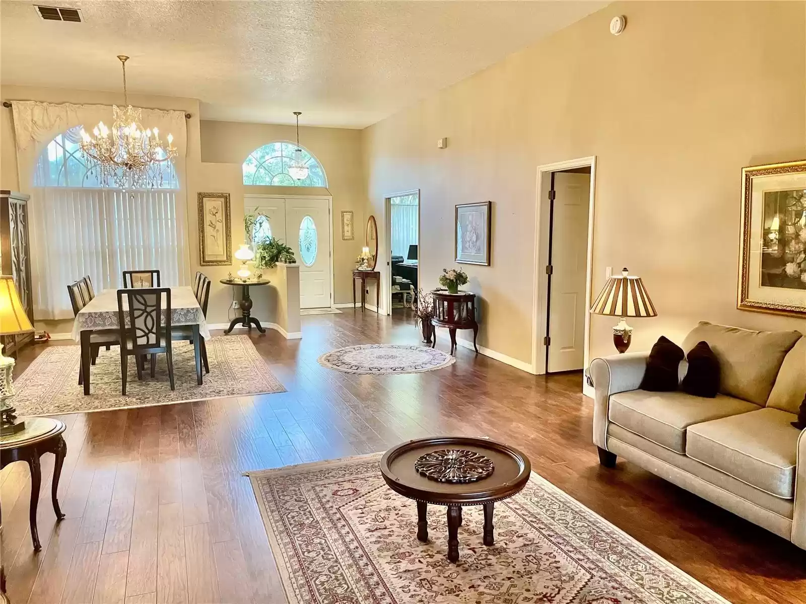 View of Living Room and Dining Room and looking AT the front door