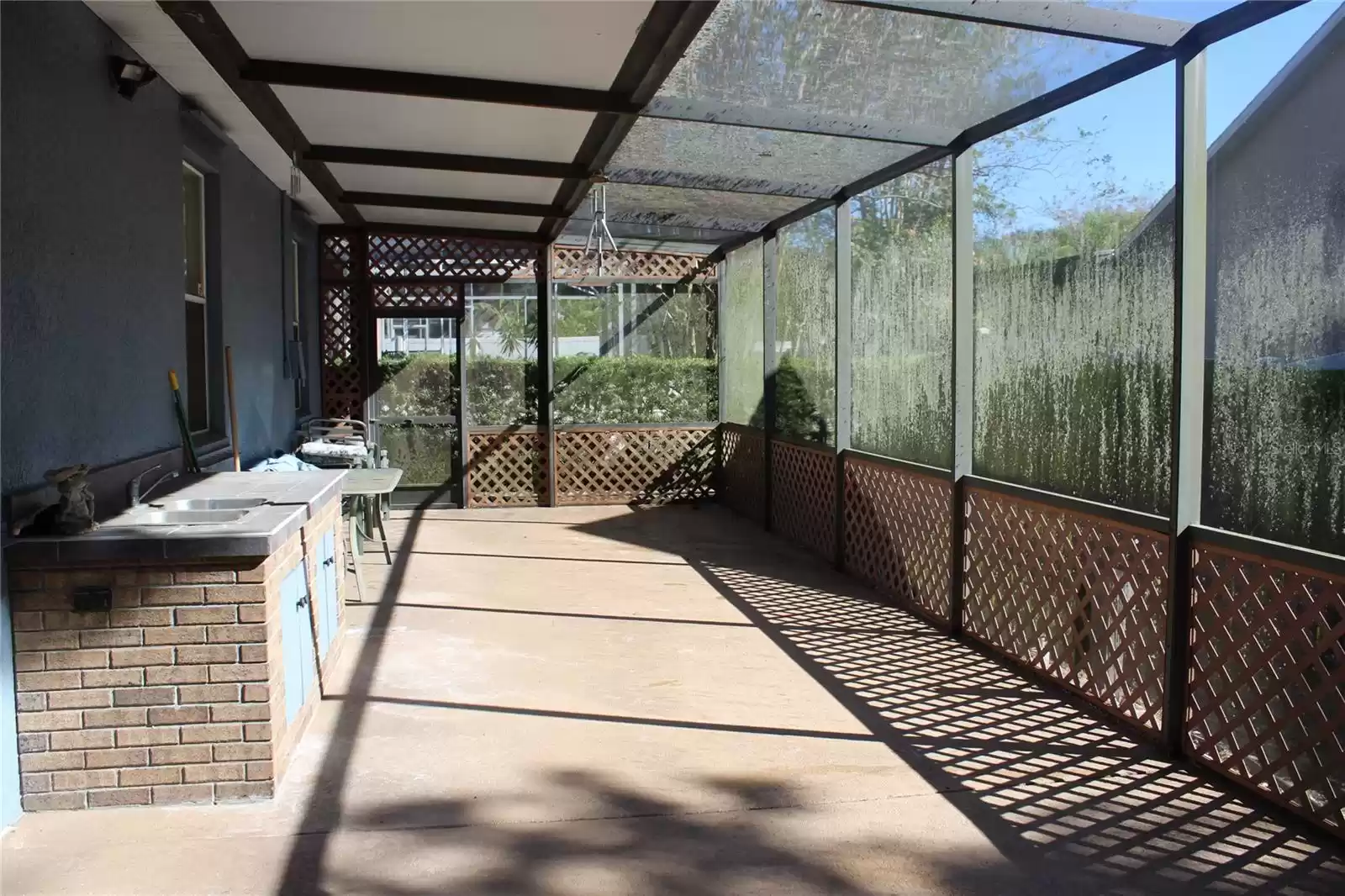 Screened in porch with functional kitchenette area