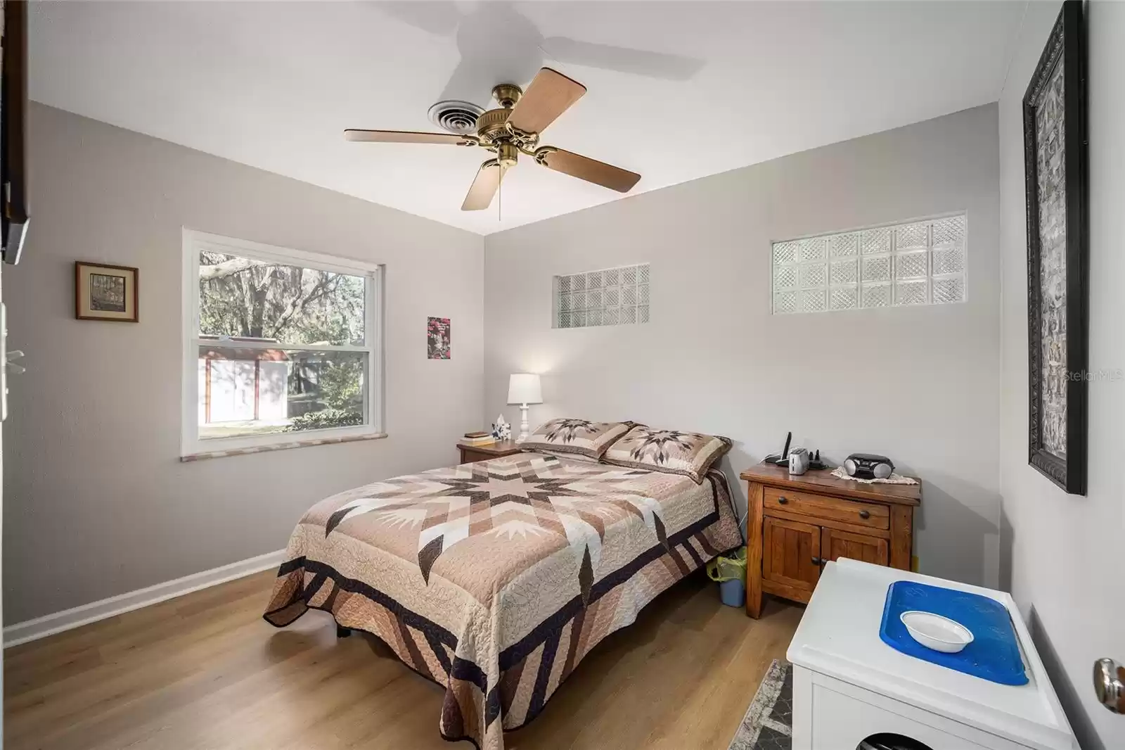 Primary Bedroom with Interior Glass Block Windows & Ceiling Fan