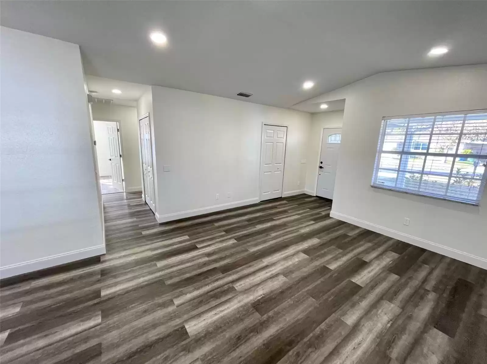 View of Living Room and Front door from Dining Room