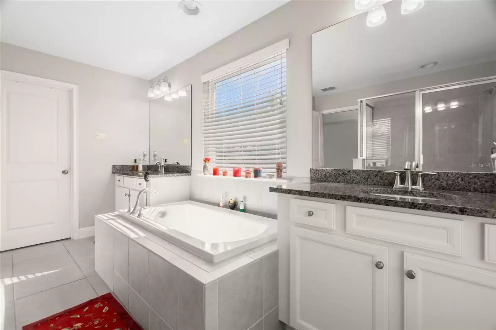 Master bath with separate double sinks and lots of storage space. Lots of natural light from windows.