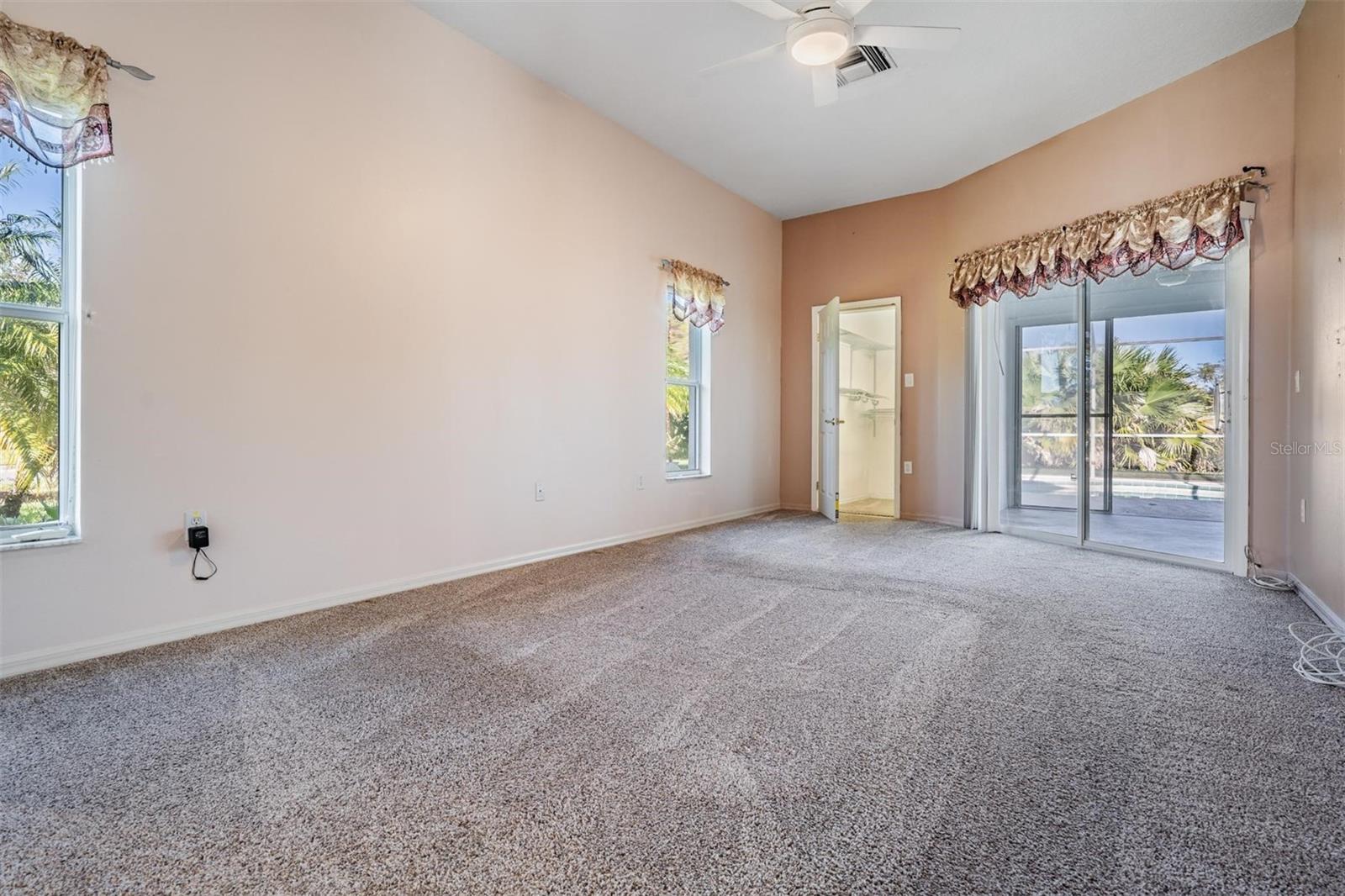 The master bedroom provides a walk-in closet and sliding glass door to lanai