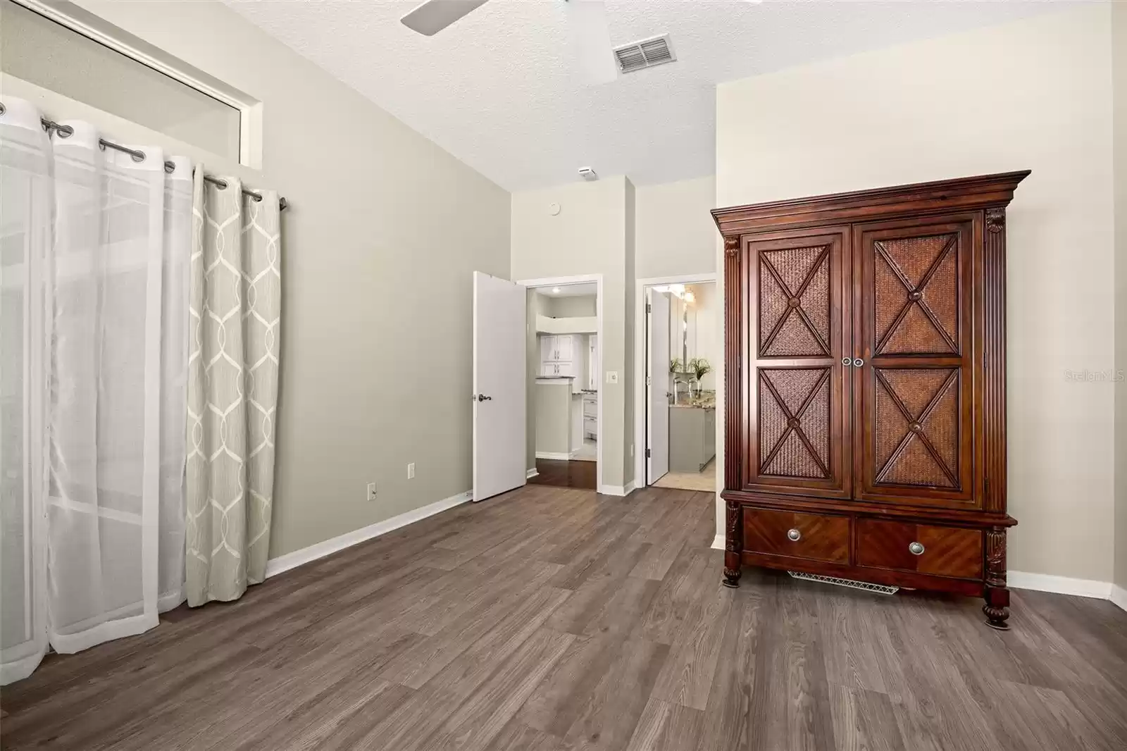 The primary suite has sliding glass doors that lead to the Florida room and a large walk-in closet.