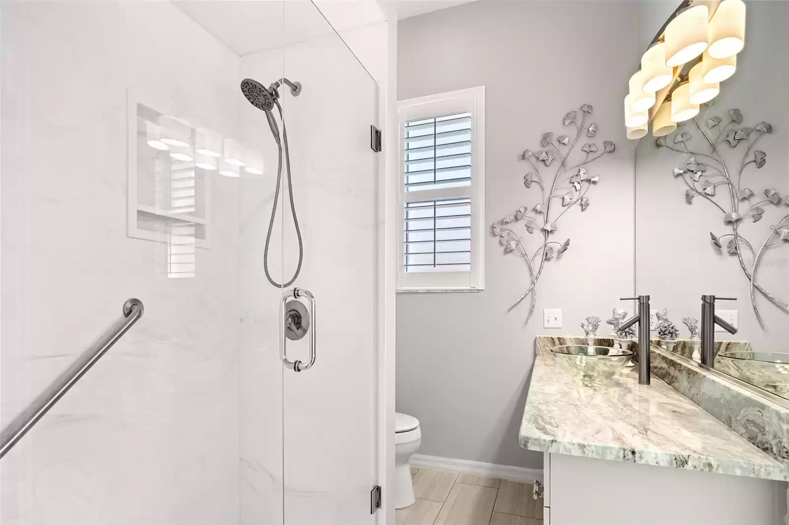 The hall bath has a walk-in shower with glass doors, GRANITE countertops and plenty of space for your guests.