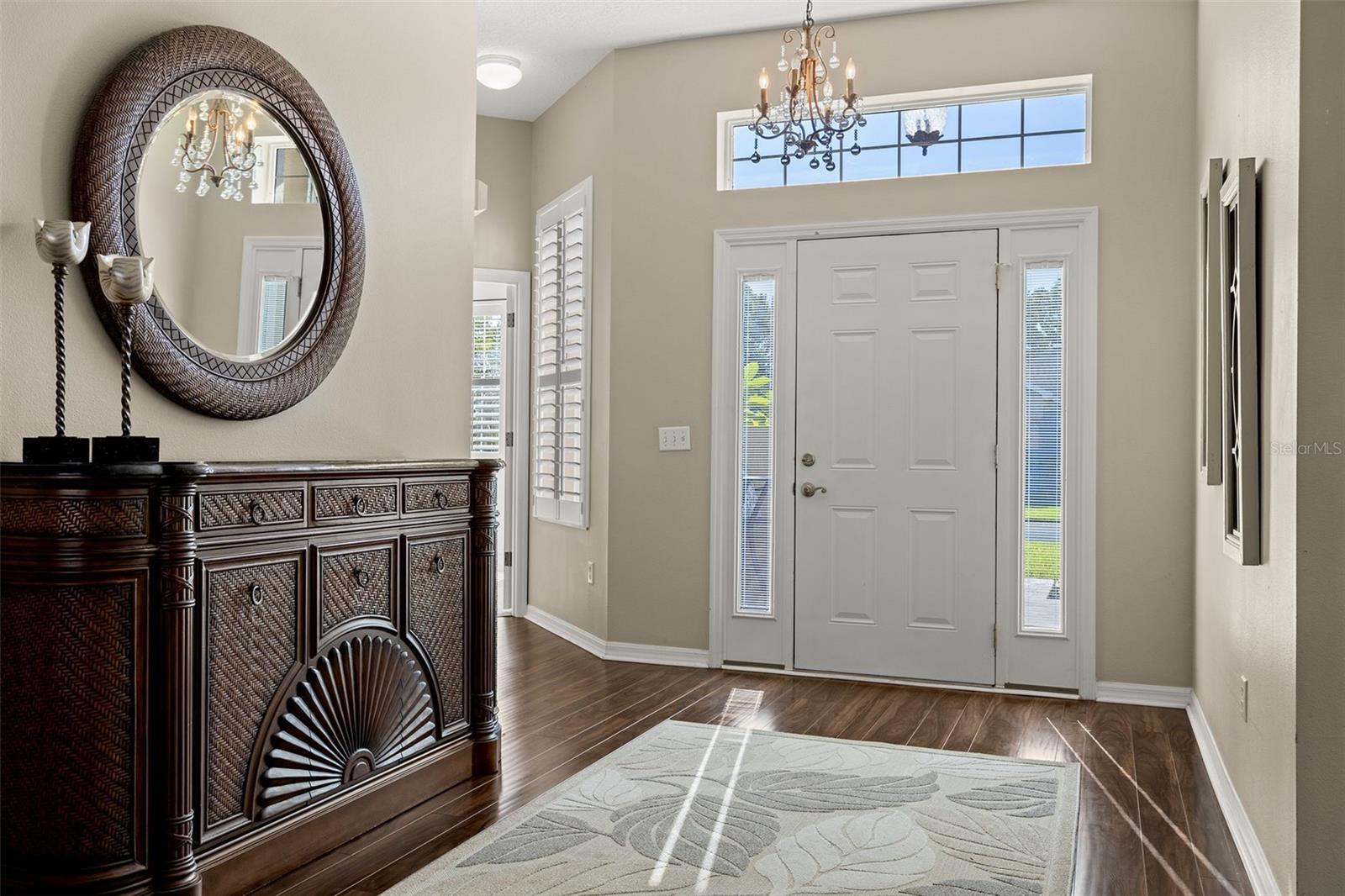 The front door has side lites and a transom window allowing for natural light to flow into the welcoming foyer.